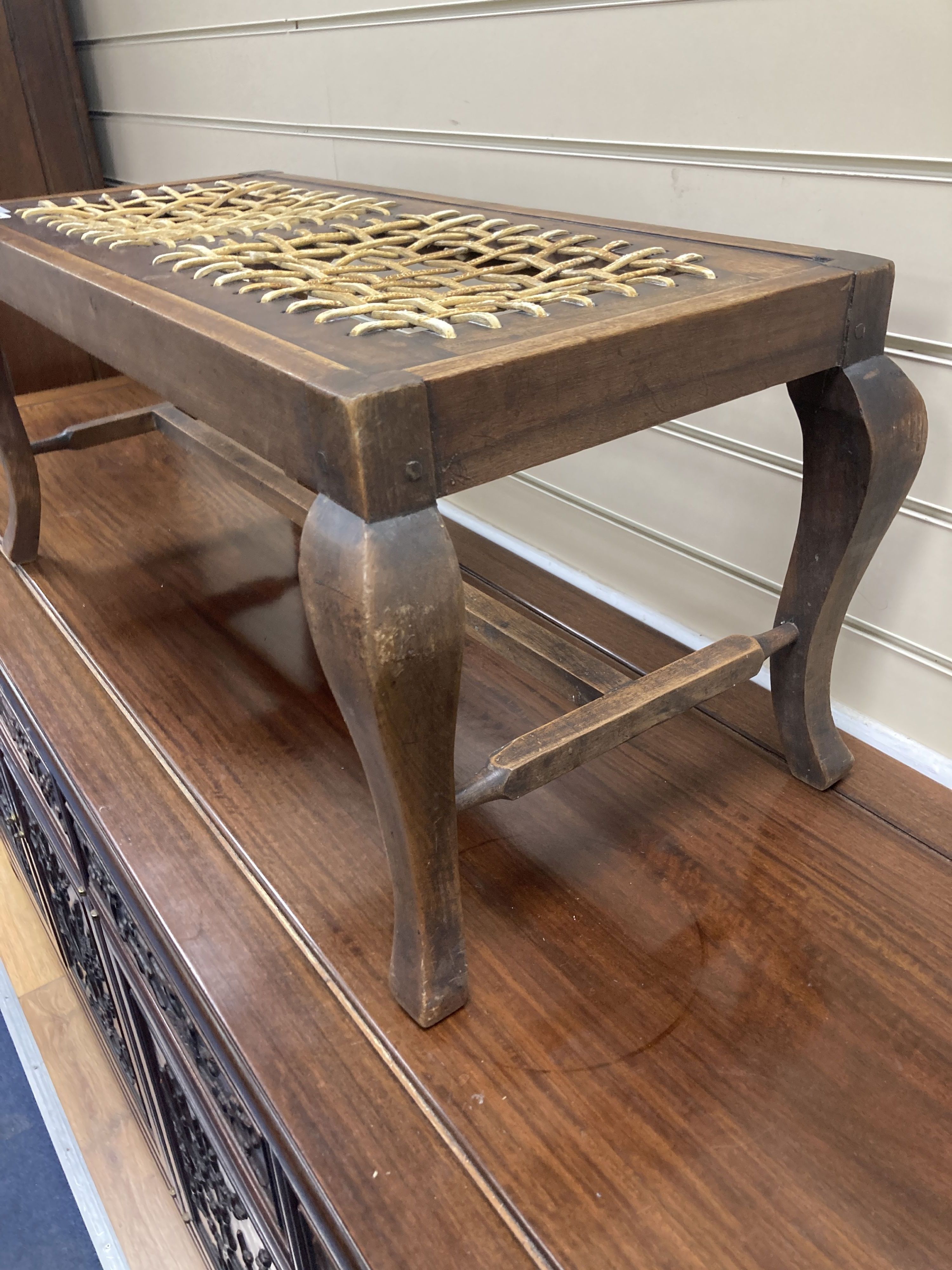 An early 20th century mahogany framed luggage stool with woven strapwork top, 35cm high, width 76cm, depth 34cm